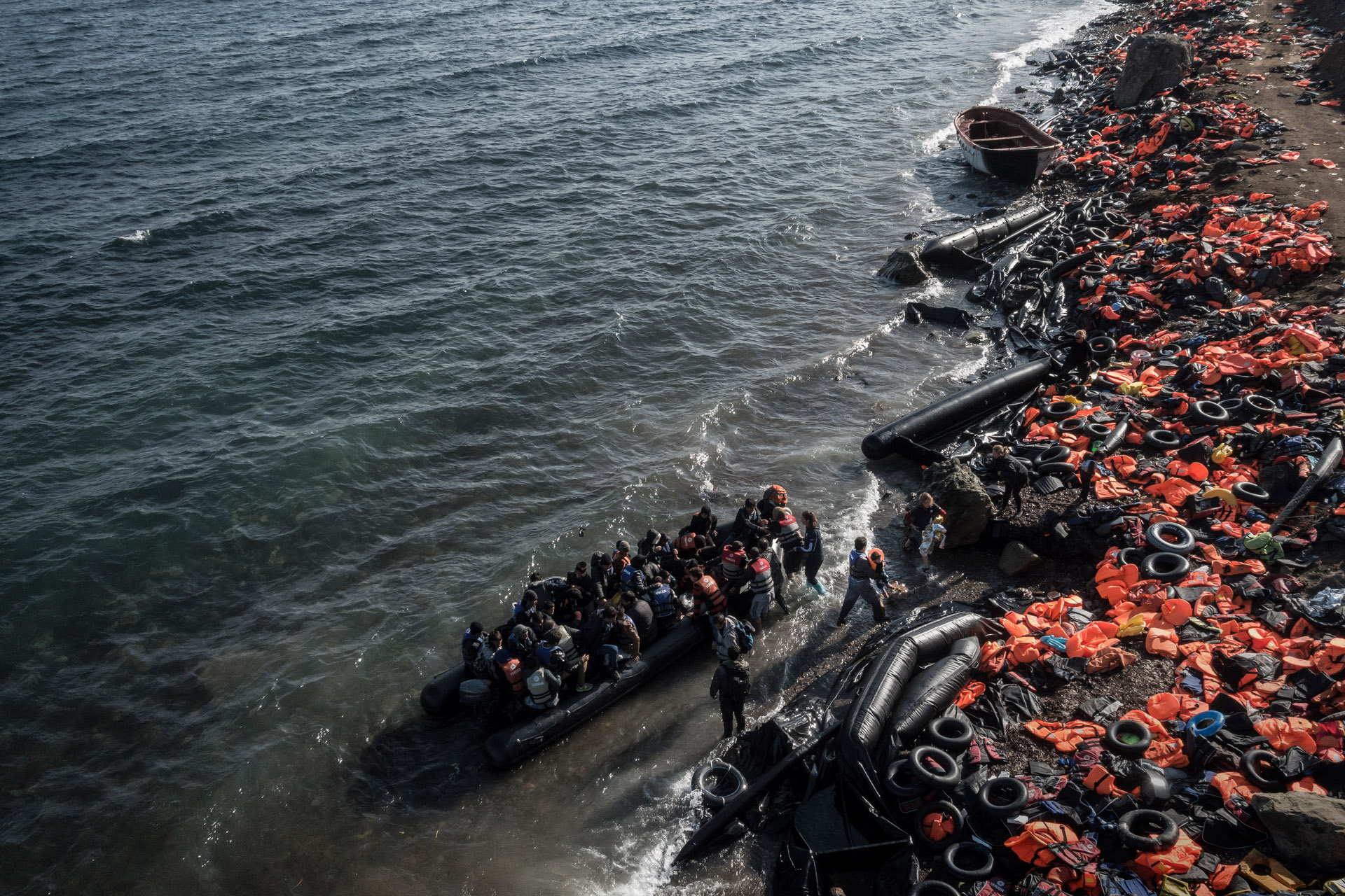 Refugees and migrants arrive on the shore in Greece.